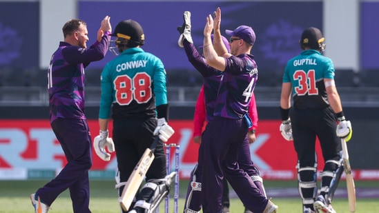 Dubai: Scotland's Mark Watt left, is congratulated by teammate Richie Berrington, right, after dismissing New Zealand's Devon Conway during the Cricket Twenty20 World Cup match between New Zealand and Scotland in Dubai, UAE, Wednesday, Nov. 3, 2021.AP/PTI(AP11_03_2021_000116A)(AP)