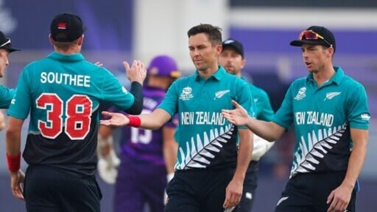 New Zealand's Trent Boult, centre, and Mitchell Santner, right, gesture to teammate Tim Southee, left after taking a catch to dismiss Scotland's captain Kyle Coetzer the Cricket Twenty20 World Cup match between New Zealand and Scotland in Dubai, UAE, Wednesday, Nov. 3, 2021. (AP Photo/Kamran Jebreili)(AP)