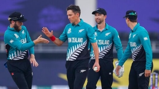 New Zealand's Trent Boult is congratulated by his captain Kane Williamson, left, after taking the wicket of Scotland's Calum MacLeod during the Cricket Twenty20 World Cup match between New Zealand and Scotland in Dubai, UAE, Wednesday, Nov. 3, 2021. (AP Photo/Kamran Jebreili)(AP)