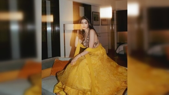 Khushi Kapoor looked breathtaking as she posed in a flared yellow lehenga which she teamed with an embellished golden backless blouse.(Instagram/@khushi05k)