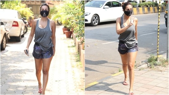 Malaika teamed the shorts with a grey colour printed tank top featuring a scooped neckline and loose silhouette. She wore the top, French-tucked inside the shorts, over a white sports bra.(HT Photo/Varinder Chawla)
