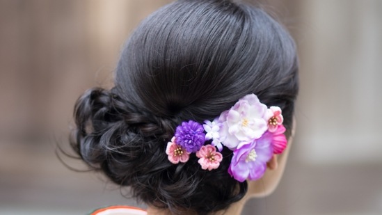 For the hairdos, she shared, "You can tie up your hair in a bun and add flowers to it. White or red roses always look stunning, or you can go for any flower that matches the colour of your outfit."(Unsplash)