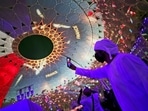 A man takes selfie under the dome of Al Wasl Plaza coloured in French national flag, during a French ceremonial day at the Dubai Expo 2020 in Dubai, United Arab Emirates(AP) A man takes selfie under the dome of Al Wasl Plaza coloured in French national flag, during a French ceremonial day at the Dubai Expo 2020 in Dubai, United Arab Emirates(AP)