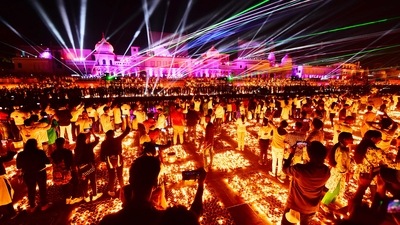 People watch a laser show on the banks of the river Sarayu during Deepotsav celebrations on the eve of the of Diwali in Ayodhya. (AFP) People watch a laser show on the banks of the river Sarayu during Deepotsav celebrations on the eve of the of Diwali in Ayodhya. (AFP)