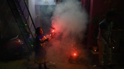 Children play with sparklers as they celebrate Diwali in New Delhi on Thursday evening.&nbsp; (AFP)