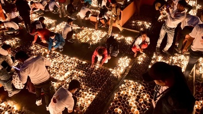 Out of 12 lakh diyas that were lit across the state, 9,51,000 earthen lamps were lit on the bank of the Saryu river in Ayodhya. (AFP) Out of 12 lakh diyas that were lit across the state, 9,51,000 earthen lamps were lit on the bank of the Saryu river in Ayodhya. (AFP)