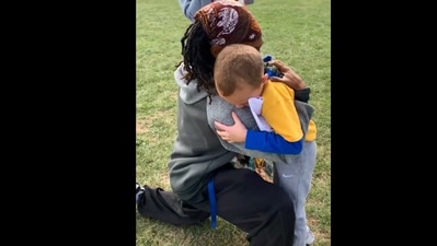 The image shows the boy hugging his coach. (Reddit/@meldiane81)