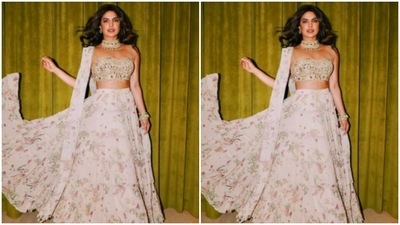 The midriff-baring ivory white blouse is embedded with silver mirrors. (Instagram/@priyankachopra) The midriff-baring ivory white blouse is embedded with silver mirrors. (Instagram/@priyankachopra)
