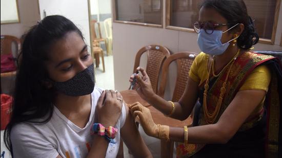 A person takes a Covid-19 vaccine shot in Mumbai, India. A total of 19 districts in Maharashtra now have less than 50 active cases. (HT Vijay Bate/HT Photo)