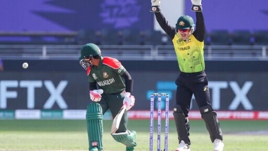 Australia's Matthew Wade, right, reacts after the dismissal of Bangladesh's Mushfiqur Rahim, left, during the Cricket Twenty20 World Cup match between Australia and Bangladesh in Dubai, UAE, Thursday, Nov. 4, 2021.(AP)