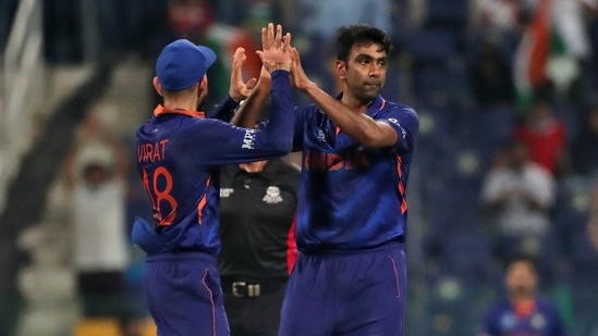 India's Ravichandran Ashwin, right, celebrates the dismissal of Afghanistan's Najibullah Zadran with captain Virat Kohli during the Cricket Twenty20 World Cup match between India and Afghanistan in Abu Dhabi, UAE, Wednesday, Nov. 3, 2021. (AP Photo/Aijaz Rahi)(AP)