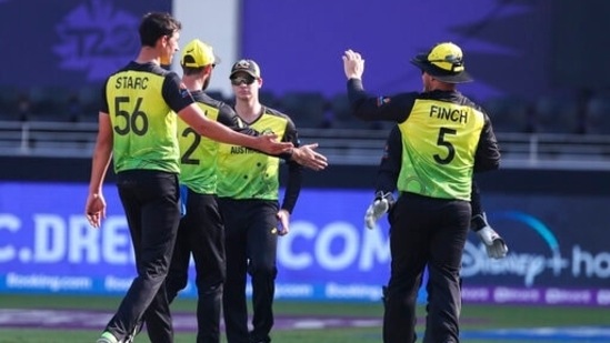 Australia's Mitchell Starc is congratulated by teammate Aaron Finch, right, after taking the wicket of Bangladesh's captain Mohammad Mahmudullah during the Cricket Twenty20 World Cup match between Australia and Bangladesh in Dubai, UAE, Thursday, Nov. 4, 2021. (AP)