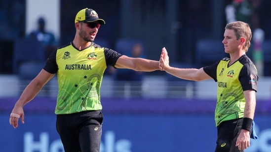 Australia's Adam Zampa, right, is congratulated by teammate Marcus Stoinis after taking the wicket of Bangladesh's Mustafizur Rahman during the Cricket Twenty20 World Cup match between Australia and Bangladesh in Dubai, UAE, Thursday, Nov. 4, 2021.(AP)