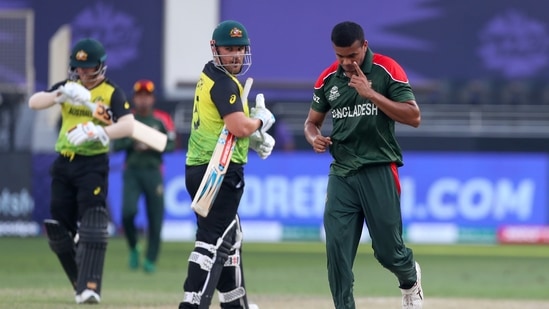 Bangladesh's Taskin Ahmed, right, celebrates after taking the wicket of Australia's captain Aaron Finch, centre, during the Cricket Twenty20 World Cup match between Australia and Bangladesh in Dubai, UAE, Thursday, Nov. 4, 2021(AP)