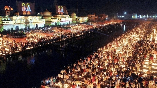 Devotees light earthen lamps on the bank of Saryu River during Deepotsav celebrations in Ayodhya.(PTI)