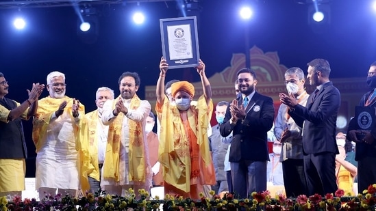 The Guinness Book of World Records team handed over the certificate to chief minister Yogi Adityanath who held it up high with both hands for the public to view it.(HT Photo)