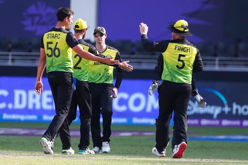 Australia's Mitchell Starc is congratulated by teammate Aaron Finch, right, after taking the wicket of Bangladesh's captain Mohammad Mahmudullah during the Cricket Twenty20 World Cup match between Australia and Bangladesh in Dubai, (AP) Australia's Mitchell Starc is congratulated by teammate Aaron Finch, right, after taking the wicket of Bangladesh's captain Mohammad Mahmudullah during the Cricket Twenty20 World Cup match between Australia and Bangladesh in Dubai, (AP)