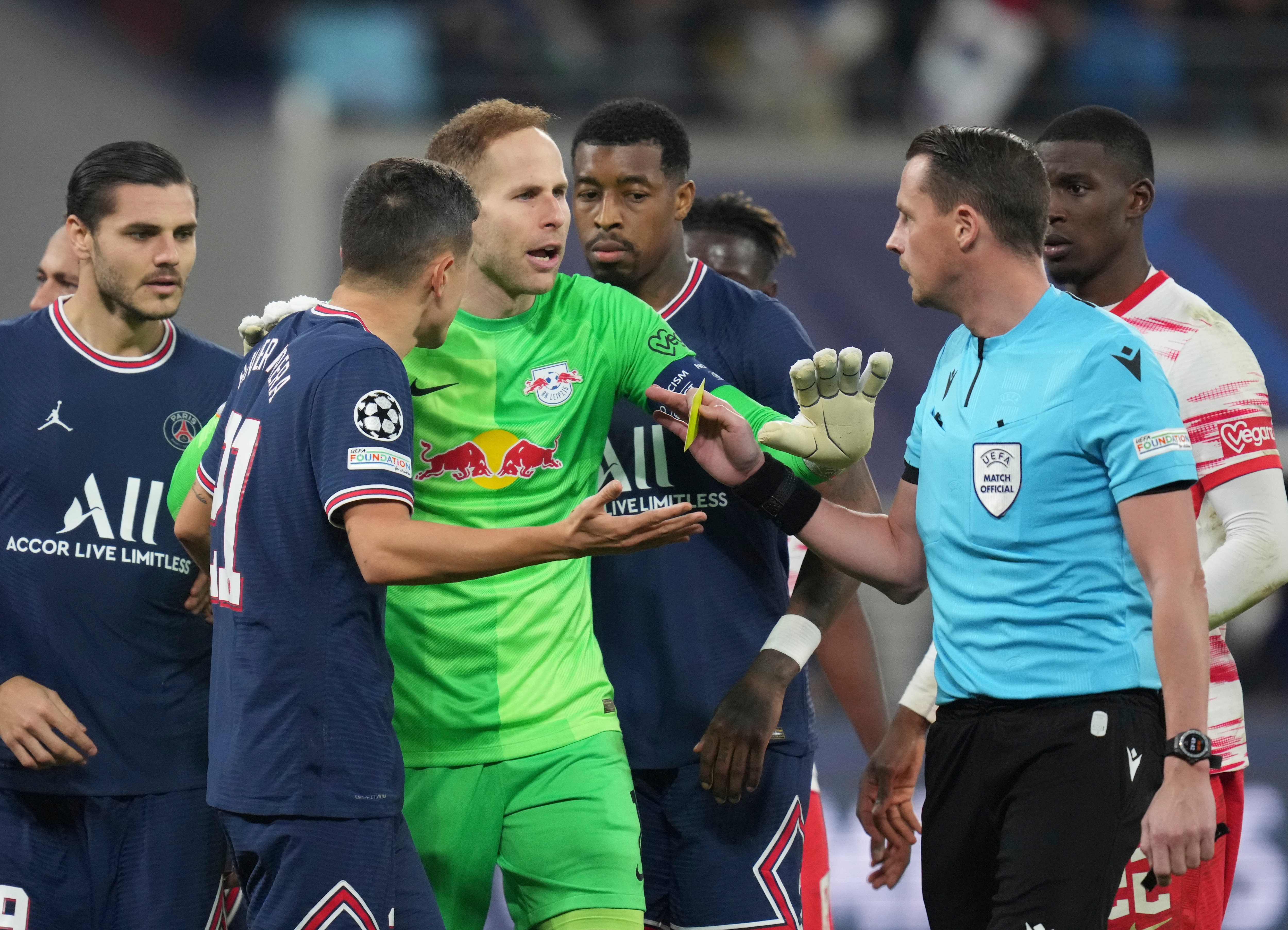 Referee Andreas Ekberg, right, discusses with Leipzig's goalkeeper Peter Gulacsi, center, and PSG's Ander Herrera, second left, during the Group A Champion's League soccer match between RB Leipzig and Paris Saint Germain at the Red Bull Arena in Leipzig, Germany, Wednesday, Nov. 3, 2021.&nbsp;(AP)