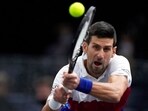 Novak Djokovic of Serbia returns the ball to U.S. Taylor Fritz during their quarterfinal match at the Paris Masters tennis tournament at the Accor Arena, in Paris, France, Friday, Nov. 5, 2021.(AP)