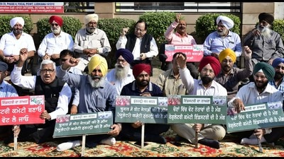 Industrialists protesting outside the UCPMA office in Gill Road, Ludhiana, on Friday against the rising prices of raw materials. (Harsimar Pal Singh/HT)