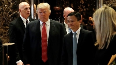 US President-elect Donald Trump walks from an elevator with Alibaba Executive Chairman Jack Ma after their meeting at Trump Tower in New York. (REUTERS)
