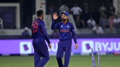 Indian cricket captain Virat Kohli, right, speaks with teammate India's Varun Chakravarthy (AP) Indian cricket captain Virat Kohli, right, speaks with teammate India's Varun Chakravarthy (AP)
