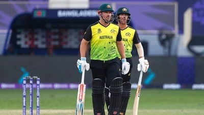 Australia's captain Aaron Finch, left, and teammate David Warner talk during the Cricket Twenty20 World Cup match between Australia and Bangladesh in Dubai, UAE, Thursday, Nov. 4, 2021. (AP) Australia's captain Aaron Finch, left, and teammate David Warner talk during the Cricket Twenty20 World Cup match between Australia and Bangladesh in Dubai, UAE, Thursday, Nov. 4, 2021. (AP)