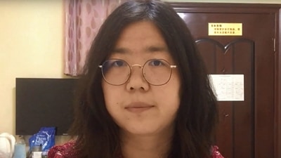 (FILES) This file screengrab taken on December 28, 2020 from an undated video showing former Chinese lawyer and citizen journalist Zhang Zhan as she broadcasts via YouTube, at an unconfirmed location in China. - Zhang, a citizen journalist jailed for her coverage of China's initial response to Covid in Wuhan, is close to death on November 5, 2021 after going on hunger strike, her family said, prompting renewed calls from rights groups for her immediate release. (AFP Photo) (FILES) This file screengrab taken on December 28, 2020 from an undated video showing former Chinese lawyer and citizen journalist Zhang Zhan as she broadcasts via YouTube, at an unconfirmed location in China. - Zhang, a citizen journalist jailed for her coverage of China's initial response to Covid in Wuhan, is close to death on November 5, 2021 after going on hunger strike, her family said, prompting renewed calls from rights groups for her immediate release. (AFP Photo)