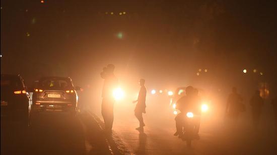 Commuters drive amid low visibility on Diwali at Narwana road as the pollution level rises, in New Delhi. (Raj K Raj/HT Photo)