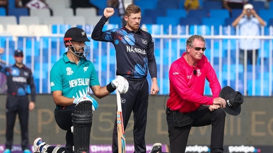 Sharjah: New Zealand's Daryl Mitchell, left, takes the knee with umpire Paul Reiffel, right, as Namibia's Bernard Scholtz stands and gestures ahead of the start the Cricket Twenty20 World Cup match between New Zealand and Namibia, in Sharjah, UAE, Friday, Nov. 5, 2021. AP/PTI(AP11_05_2021_000160A)(AP)