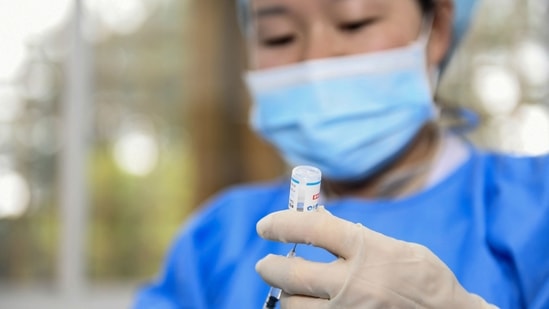 A medical worker prepares a dose of the Covid-19 coronavirus vaccine in Anlong, in China's southwestern Guizhou province on November 4, 2021. (AFP) A medical worker prepares a dose of the Covid-19 coronavirus vaccine in Anlong, in China's southwestern Guizhou province on November 4, 2021. (AFP)
