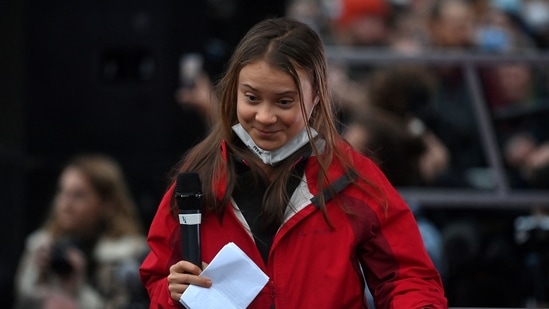 Swedish climate activist Greta Thunberg walks on stage in George Square at the end point for the Fridays For Future youth rally in Glasgow.(AFP)