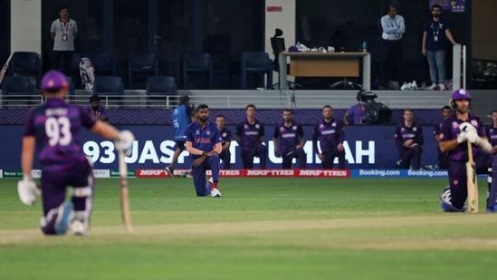 India's Hardik Pandya, Scotland's George Munsey, left, take the knee before the start of the Cricket Twenty20 World Cup match between India and Scotland in Dubai, UAE, Friday, Nov. 5, 2021. (AP Photo/Aijaz Rahi)(AP)