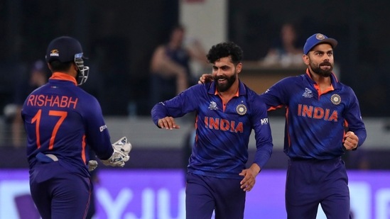 India's Ravindra Jadeja, center, celebrates with captain Virat Kohli, right, and Rishabh Pant the dismissal of Scotland's Matthew Cross during the Cricket Twenty20 World Cup match between India and Scotland in Dubai, UAE, Friday, Nov. 5, 2021. (AP)