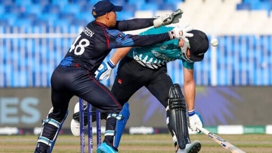 New Zealand's Jimmy Neesham, right, reaches out to make his grown as Namibia's wicketkeeper Zane Green looks to catch the ball during the Cricket Twenty20 World Cup match between New Zealand and Namibia, in Sharjah, UAE, Friday, Nov. 5, 2021. (AP Photo/Kamran Jebreili)(AP)
