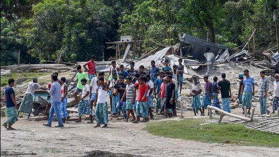 Villagers near their houses which were demolished during an eviction drive, at Gorukhuti in Assam’s Darrang district, in September. (PTI) Villagers near their houses which were demolished during an eviction drive, at Gorukhuti in Assam’s Darrang district, in September. (PTI)
