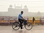 A man rides a bicycle in front of the historic Red Fort, shrouded in smog post-Diwali celebrations in New Delhi.&nbsp;