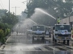 Public Works Department (PWD) workers spray water to curb the air pollution in New Delhi on November 6, 2021. (ANI Photo)(Ishant Kumar) Public Works Department (PWD) workers spray water to curb the air pollution in New Delhi on November 6, 2021. (ANI Photo)(Ishant Kumar)