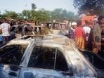 People look on at burnt cars in the aftermath of a fuel tanker explosion in Freetown.(AFP) People look on at burnt cars in the aftermath of a fuel tanker explosion in Freetown.(AFP)