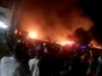 People look at fire blaze following a fuel tanker explosion in Freetown, Sierra Leone, in this still image obtained from a social media video. November 6, 2021.