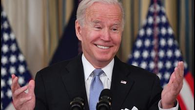 US President Joe Biden reacts as he delivers remarks on the passage of the Bipartisan Infrastructure Deal and the rule that will allow the passage of the Build Back Better Act in the State Dining Room at the White House in Washington, DC on Saturday. (AFP)