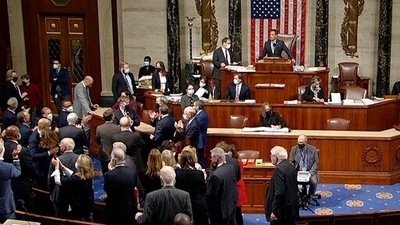 Democrats celebrate on the House floor late Friday, Nov. 5, 2021, in Washington, after the House approved a $1 trillion package of road and other infrastructure projects. (AP) Democrats celebrate on the House floor late Friday, Nov. 5, 2021, in Washington, after the House approved a $1 trillion package of road and other infrastructure projects. (AP)
