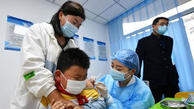 A child being vaccinated against the Covid-19 coronavirus at a primary school in Qingdao, in China's eastern Shandong province. (AFP)