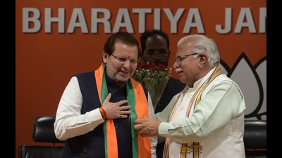 File photo of BJP leader Arvind Sharma with former Haryana chief minister Manohar Lal Khattar. (HT file photo) File photo of BJP leader Arvind Sharma with former Haryana chief minister Manohar Lal Khattar. (HT file photo)
