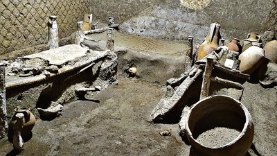A “slaves room” at a Roman villa, containing beds, amphorae, ceramic pitchers and a chamber pot is discovered in a dig near the ancient Roman city of Pompeii (AP)