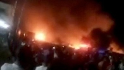 People look at fire blaze following a fuel tanker explosion in Freetown, Sierra Leone, in this still image obtained from a social media video. November 6, 2021. ( Facebook @FODAY.KONDEH.5/via REUTERS)