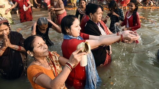 Women take a dip in the holy river and perform rituals on the occasion of Bhai Dooj, in Prayagraj.(ANI)