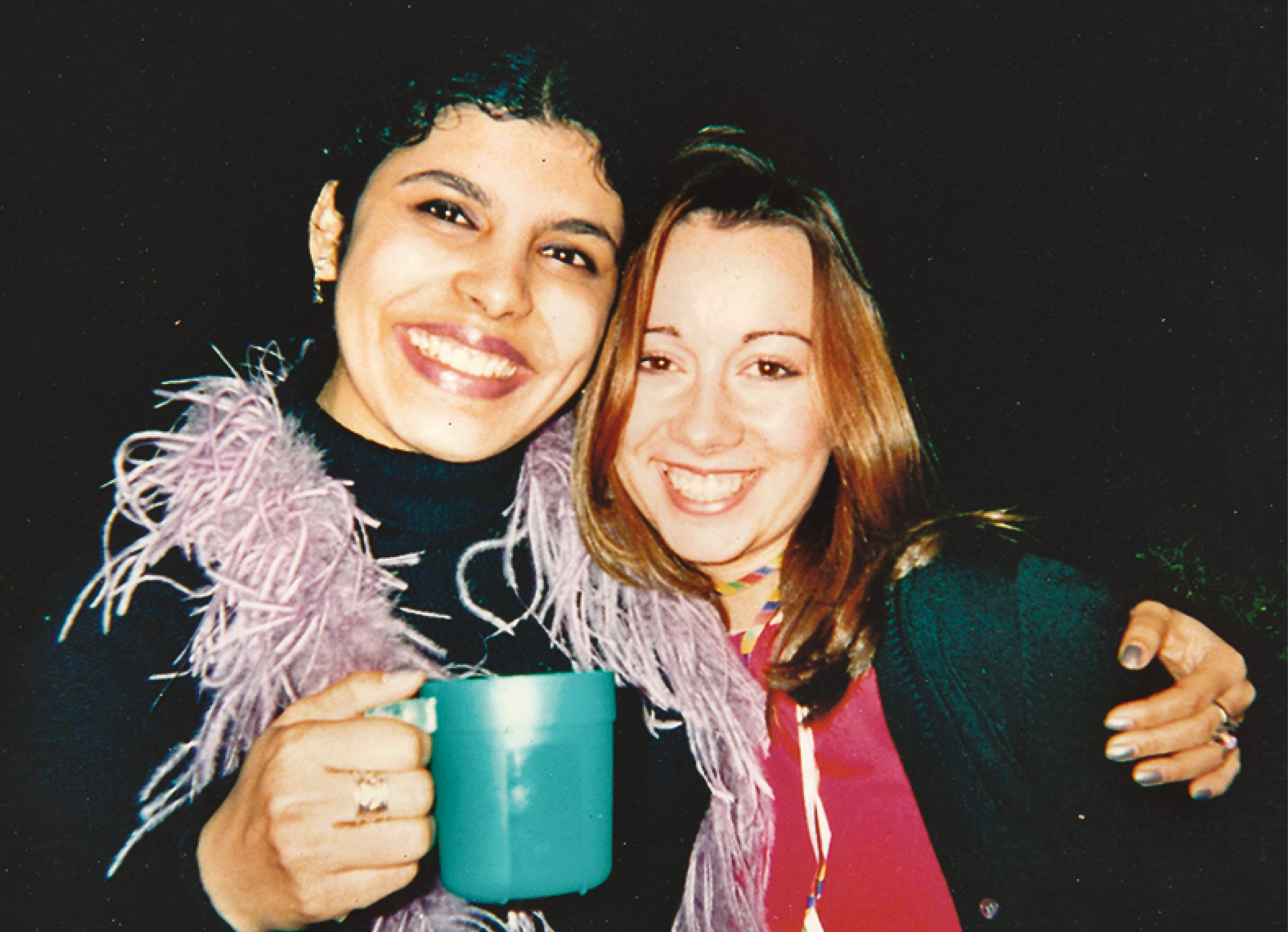 Being a teetotaller with a cup of juice, with her friend Laura at a house party Being a teetotaller with a cup of juice, with her friend Laura at a house party