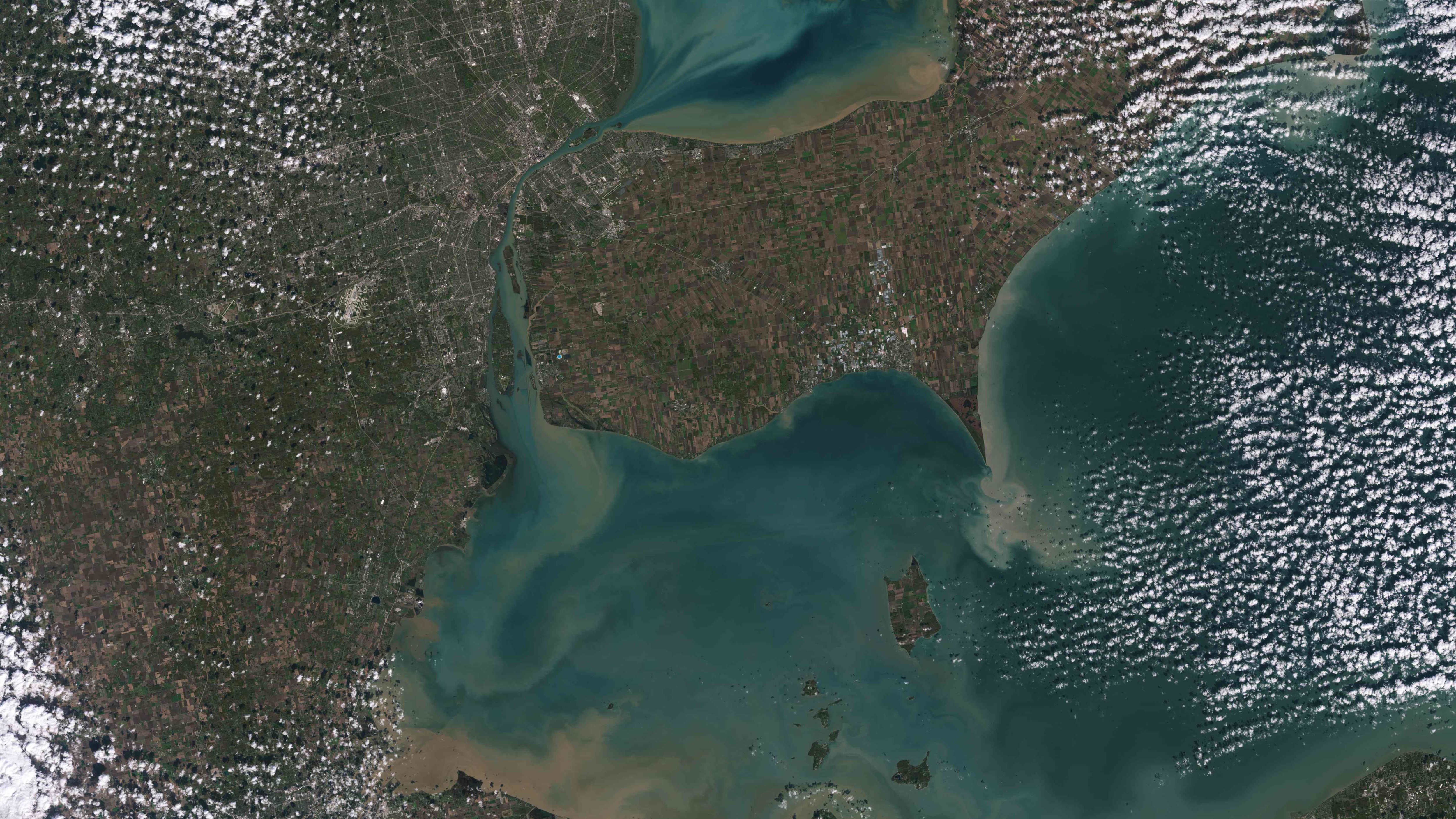 This image collected by Landsat 9 on October 31, 2021, and released by NASA, shows sediments swirling in Lake Erie and Lake St. Clair in this image of both Detroit, Michigan, and Windsor, Ontario. - The Great Lakes serve as sources of fresh water, recreational activity, transport, and habitat for the upper-midwestern United States, and water quality remains a high priority. In warmer months, Landsat 9 observes swirls of green algae which can become harmful algal blooms. (Photo by Handout / various sources / AFP) This image collected by Landsat 9 on October 31, 2021, and released by NASA, shows sediments swirling in Lake Erie and Lake St. Clair in this image of both Detroit, Michigan, and Windsor, Ontario. - The Great Lakes serve as sources of fresh water, recreational activity, transport, and habitat for the upper-midwestern United States, and water quality remains a high priority. In warmer months, Landsat 9 observes swirls of green algae which can become harmful algal blooms. (Photo by Handout / various sources / AFP)