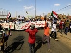 Protesters carry a banner and national flags as they march against the Sudanese military's recent seizure of power and ousting of the civilian government, in the streets of the capital Khartoum, Sudan. (REUTERS) Protesters carry a banner and national flags as they march against the Sudanese military's recent seizure of power and ousting of the civilian government, in the streets of the capital Khartoum, Sudan. (REUTERS)
